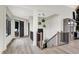 Hallway with wooden floors, staircase with metal spindles, and decorative lighting at 7116 Trail Ridge Ln, Indianapolis, IN 46259