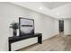 Bright hallway features wood floors, white walls, and a stylish console table with modern art at 7116 Trail Ridge Ln, Indianapolis, IN 46259