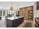 Elegant kitchen with an island, pantry, and open layout to the dining and living spaces at 7116 Trail Ridge Ln, Indianapolis, IN 46259