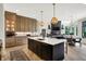 Open-concept kitchen with a large island, stainless appliances, and seamless flow to living spaces at 7116 Trail Ridge Ln, Indianapolis, IN 46259