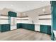 Well-appointed kitchenette features ample emerald-green cabinetry, bright countertops, and stainless steel appliances at 7116 Trail Ridge Ln, Indianapolis, IN 46259