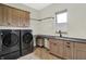 Modern laundry room with front-load washer and dryer, countertops, and natural light at 7116 Trail Ridge Ln, Indianapolis, IN 46259