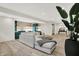 This bright living room offers a stylish sectional sofa and kitchenette with striking green cabinets at 7116 Trail Ridge Ln, Indianapolis, IN 46259