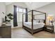 Bedroom featuring a four-poster bed, neutral decor, and ample natural light at 7116 Trail Ridge Ln, Indianapolis, IN 46259