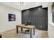 Bright home office features a large built-in cabinet, hardwood floors, and modern decor at 7116 Trail Ridge Ln, Indianapolis, IN 46259