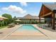 Backyard features a pool with lounge seating, dining, and covered outdoor living space at 7116 Trail Ridge Ln, Indianapolis, IN 46259