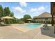 Backyard features a pool with an automatic cover, lounge chairs, and outdoor dining at 7116 Trail Ridge Ln, Indianapolis, IN 46259