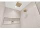 Modern walk-in shower featuring herringbone tile, a built-in niche, and dual rainfall shower heads at 7116 Trail Ridge Ln, Indianapolis, IN 46259