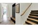 Mudroom with staircase and built-in storage bench featuring coat rack and shoe cubbies at 7116 Trail Ridge Ln, Indianapolis, IN 46259