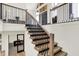 Staircase with iron railing leads to an open living space with lots of natural light at 7116 Trail Ridge Ln, Indianapolis, IN 46259