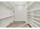 Spacious walk-in closet featuring custom shelving and ample storage for organization at 7116 Trail Ridge Ln, Indianapolis, IN 46259