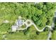 Aerial view of an estate featuring a long driveway, mature trees, and a well-manicured lawn at 7182 Hunt Club Dr, Zionsville, IN 46077