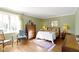Inviting bedroom with hardwood floors, large windows, and elegant furnishings at 7182 Hunt Club Dr, Zionsville, IN 46077