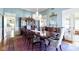 Elegant dining room with a grand table set for twelve, ornate chandelier, and stylish decor at 7182 Hunt Club Dr, Zionsville, IN 46077