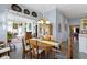 Traditional dining room with hardwood table, decorative plates, and view into the living room at 7182 Hunt Club Dr, Zionsville, IN 46077