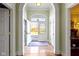 Welcoming entryway with arched doorways and decorative glass doors leading to sun-drenched interiors at 7182 Hunt Club Dr, Zionsville, IN 46077