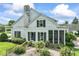 Charming two-story home with classic architectural details, including a screened-in porch and garden at 7182 Hunt Club Dr, Zionsville, IN 46077