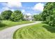 Classic home with a pillared porch surrounded by a spacious, well-maintained green lawn and mature trees at 7182 Hunt Club Dr, Zionsville, IN 46077