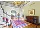 Grand foyer with a soaring ceiling, elegant staircase, hardwood floors, and views into adjacent rooms at 7182 Hunt Club Dr, Zionsville, IN 46077