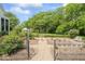 Scenic garden featuring an iron gate, gravel pathway, and lush green surroundings, with a partial view of the home at 7182 Hunt Club Dr, Zionsville, IN 46077
