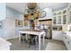 Well-equipped kitchen with island, pot rack, and stainless steel appliances offers both style and functionality at 7182 Hunt Club Dr, Zionsville, IN 46077