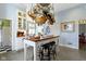 Charming kitchen featuring an island with barstools, open shelving, and access to additional living spaces at 7182 Hunt Club Dr, Zionsville, IN 46077