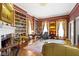 Elegant library featuring bespoke bookshelves, fireplace, and inviting sitting area with classic design elements at 7182 Hunt Club Dr, Zionsville, IN 46077