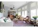 Bright living room with shuttered windows, comfortable seating, and view into the dining room at 7182 Hunt Club Dr, Zionsville, IN 46077