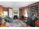 Cozy living room with built-in bookshelves, a fireplace, and comfortable seating at 7182 Hunt Club Dr, Zionsville, IN 46077