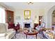 Elegant living room with a fireplace, classic furnishings, and an arched doorway showcasing timeless charm at 7182 Hunt Club Dr, Zionsville, IN 46077