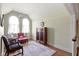 Cozy sitting room featuring arched windows, hardwood floors and tasteful vintage furnishings at 7182 Hunt Club Dr, Zionsville, IN 46077