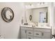 Well-lit bathroom with double sinks, white cabinetry, a decorative mirror, and modern hardware at 7258 Selah Ln, Noblesville, IN 46062