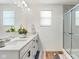 Clean bathroom featuring double sinks, granite countertops, and a tiled walk-in shower at 7258 Selah Ln, Noblesville, IN 46062