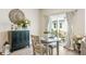 Charming dining area with stylish decor, a dark cabinet and sliding glass door to the backyard at 7258 Selah Ln, Noblesville, IN 46062