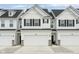 New construction townhouse with attached garage, black shutters and gray landscaping at 7258 Selah Ln, Noblesville, IN 46062