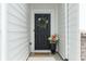 Charming front entry with a black door, floral wreath, and inviting decor at 7258 Selah Ln, Noblesville, IN 46062