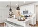 Bright kitchen featuring white cabinets, stainless steel appliances and a center island with seating at 7258 Selah Ln, Noblesville, IN 46062
