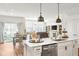 Bright open-concept kitchen with stainless steel appliances and connected living area at 7258 Selah Ln, Noblesville, IN 46062