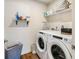 Functional laundry room with modern washer and dryer, plus ample storage shelving at 7258 Selah Ln, Noblesville, IN 46062
