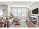Cozy living room with large windows, plush seating, fireplace and stylish decor at 7258 Selah Ln, Noblesville, IN 46062