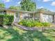 Inviting entryway with a well-manicured garden, adding to the home's curb appeal at 726 Coach Rd, Indianapolis, IN 46227