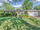 Charming one-story brick home featuring an attached garage and lush front yard landscaping at 726 Coach Rd, Indianapolis, IN 46227