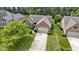 Aerial view of the brick home with an attached garage, a beautiful lawn, and mature trees at 7335 Pymbroke Dr, Fishers, IN 46038