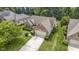 Aerial view of the brick home showing an attached garage, lawn, and well-maintained yard at 7335 Pymbroke Dr, Fishers, IN 46038