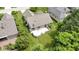 An aerial view of the house showcasing the back deck, well-manicured lawn, and mature landscaping at 7335 Pymbroke Dr, Fishers, IN 46038