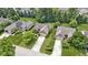 Aerial view of a brick house with attached garage, driveway, manicured landscaping, and mature trees at 7335 Pymbroke Dr, Fishers, IN 46038