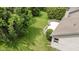 Aerial shot of backyard featuring a well-maintained lawn and a wooden deck, surrounded by lush greenery at 7335 Pymbroke Dr, Fishers, IN 46038
