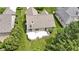 An aerial view of the house showcasing the back deck, well-manicured lawn, and mature landscaping at 7335 Pymbroke Dr, Fishers, IN 46038