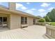 A view of the back deck showing the wood finish, seating, sliding door, and access to the yard at 7335 Pymbroke Dr, Fishers, IN 46038