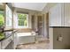 Well-lit bathroom with a soaking tub, glass-enclosed shower, and stone accents at 7335 Pymbroke Dr, Fishers, IN 46038